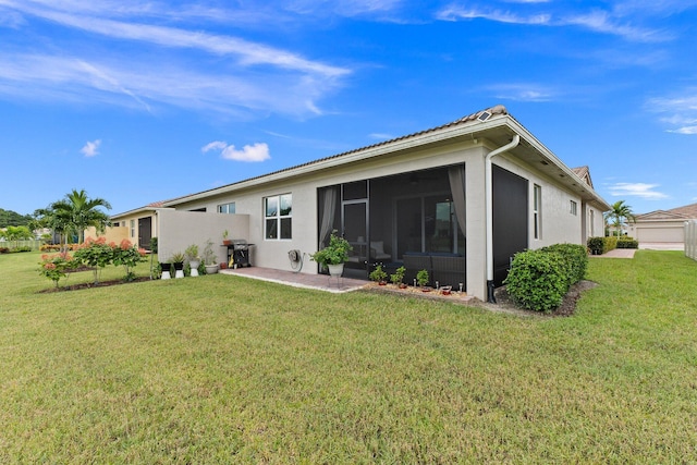 rear view of property featuring a sunroom and a yard