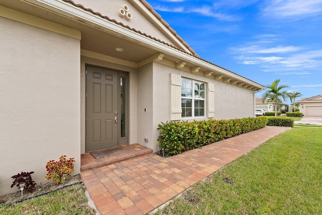 property entrance with a yard