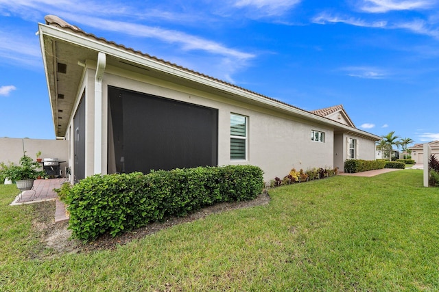 view of side of property with a yard