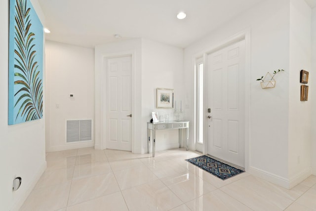 entryway with light tile patterned floors