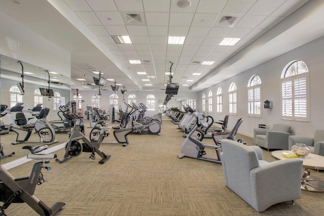 gym with light colored carpet and a drop ceiling