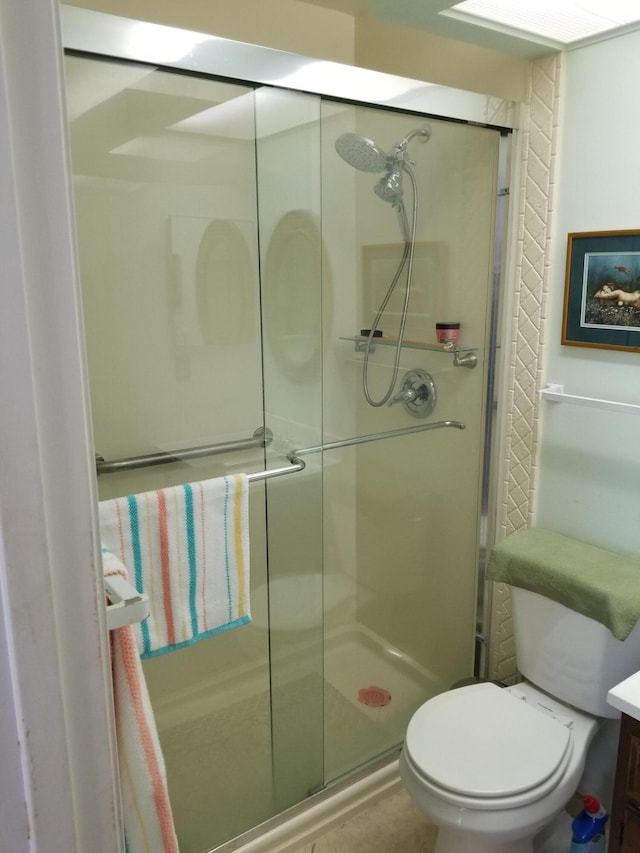 bathroom with walk in shower, vanity, and toilet