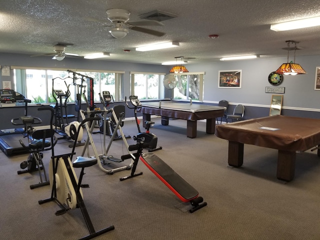 workout area featuring pool table, ceiling fan, and a textured ceiling