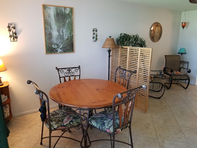 dining space featuring light tile patterned flooring