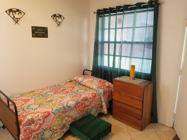 bedroom featuring light tile patterned flooring