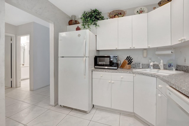 kitchen featuring white cabinets, white appliances, light tile patterned floors, and sink