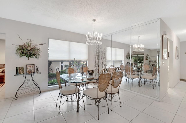 tiled dining space featuring a textured ceiling and a chandelier