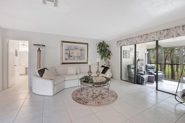 tiled living room featuring a textured ceiling