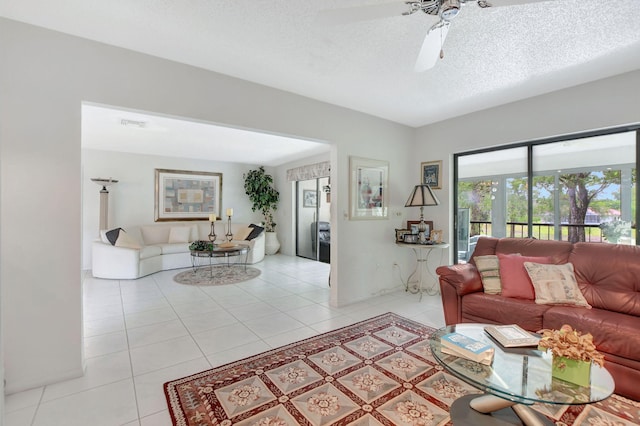 tiled living room with a textured ceiling and ceiling fan