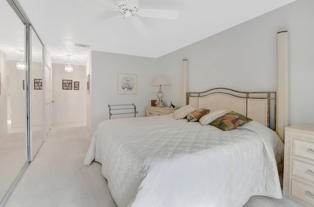 bedroom with ceiling fan and light colored carpet