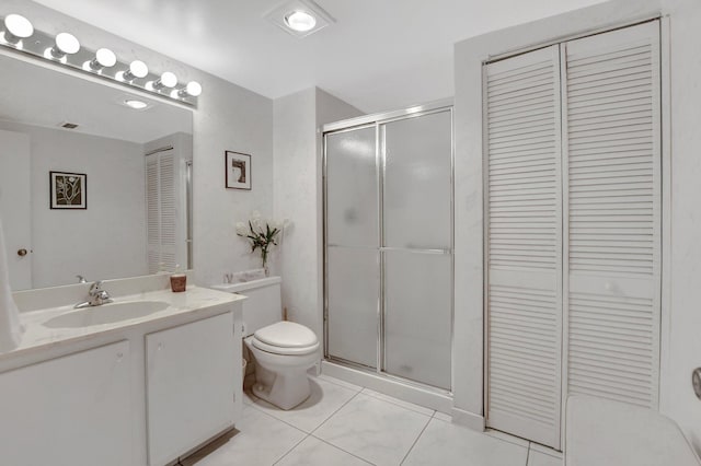 bathroom with tile patterned floors, an enclosed shower, vanity, and toilet