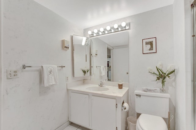 bathroom featuring vanity, toilet, and tile patterned floors