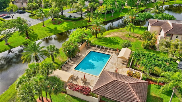 view of pool with a water view, a yard, and a patio area