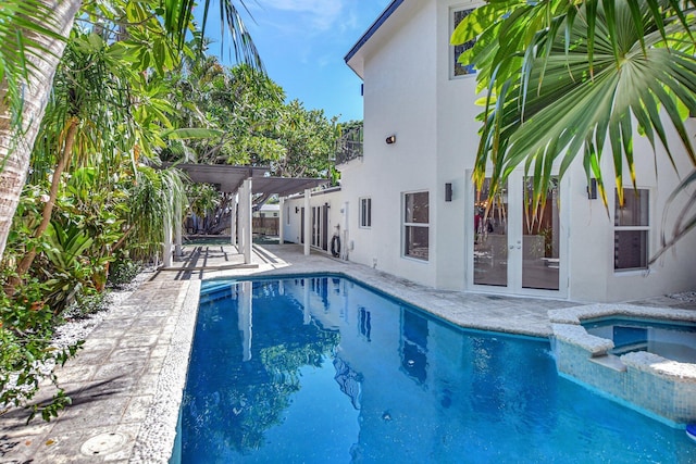 view of pool with a patio, an in ground hot tub, and a pergola