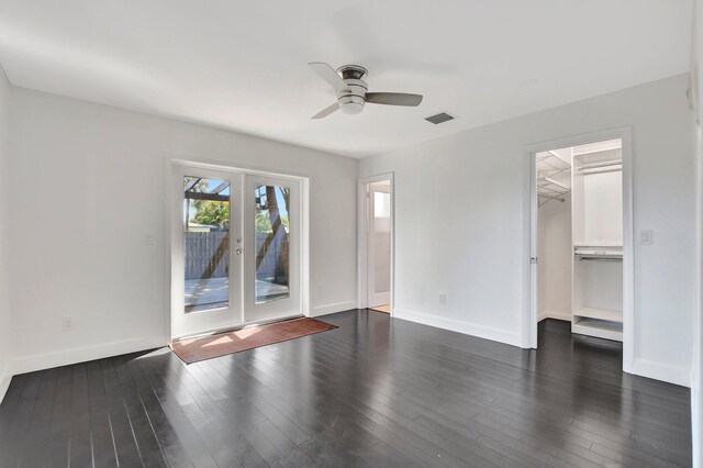 empty room featuring french doors, dark hardwood / wood-style flooring, and ceiling fan