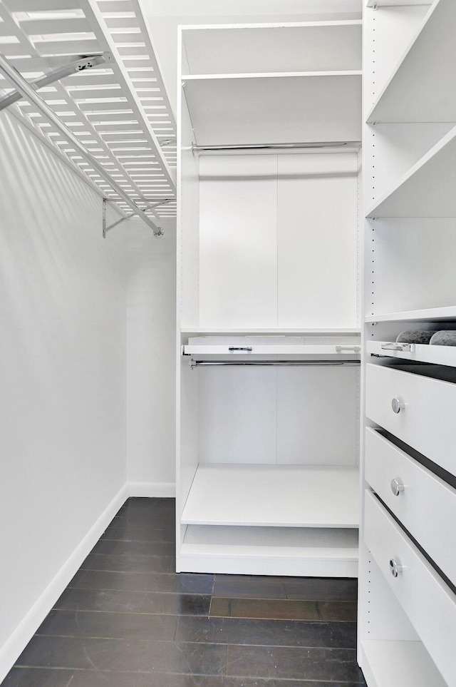 walk in closet featuring dark wood-type flooring