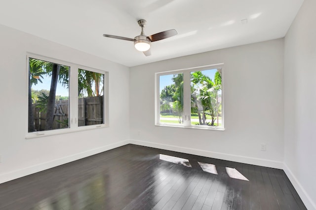 unfurnished room featuring dark wood-type flooring and ceiling fan