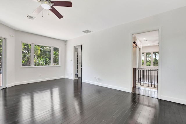 spare room with ceiling fan and dark hardwood / wood-style flooring