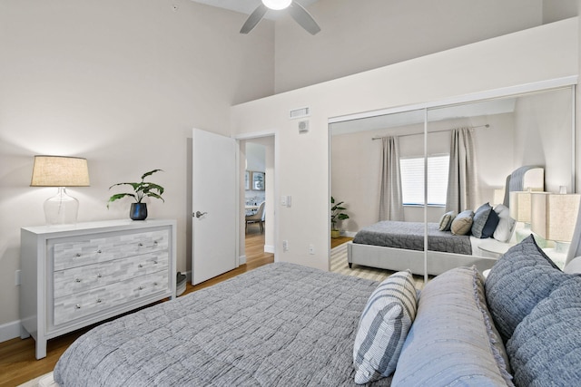 bedroom with ceiling fan, a closet, and light wood-type flooring