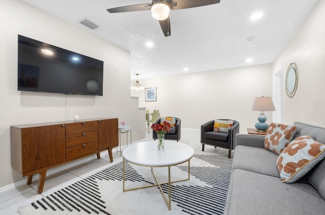 tiled living room featuring ceiling fan