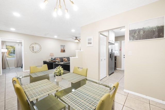 dining room with ceiling fan and light tile patterned flooring