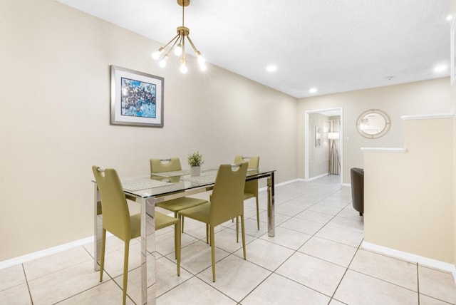 tiled dining room with an inviting chandelier