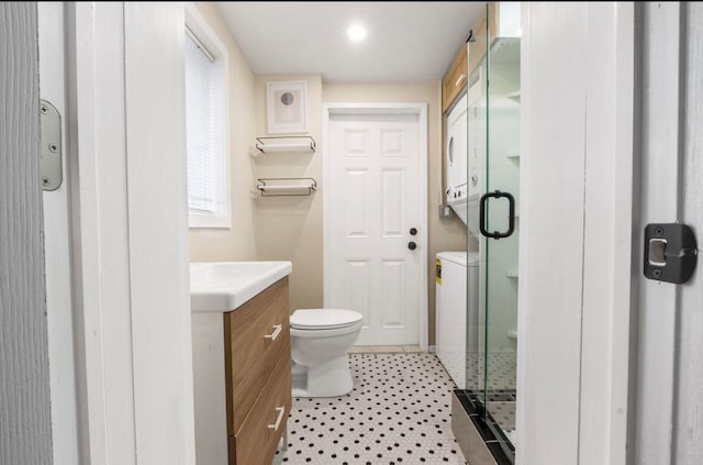 bathroom featuring vanity, toilet, and an enclosed shower