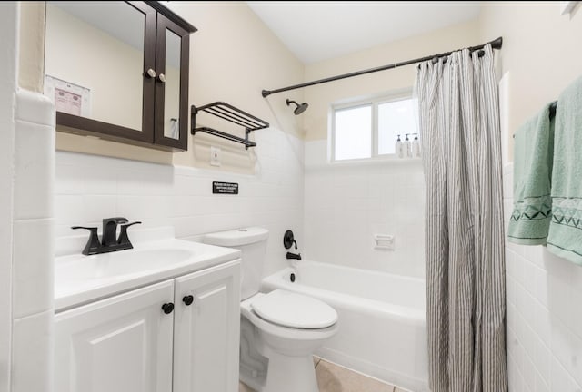 full bathroom with tile walls, shower / tub combo, vanity, toilet, and tile patterned floors