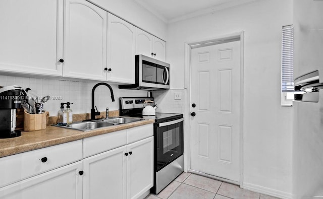 kitchen with white cabinets, appliances with stainless steel finishes, sink, and decorative backsplash