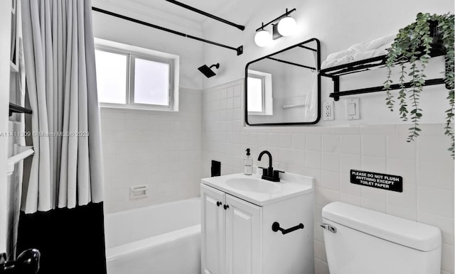 full bathroom with tile walls, shower / tub combo, vanity, and toilet