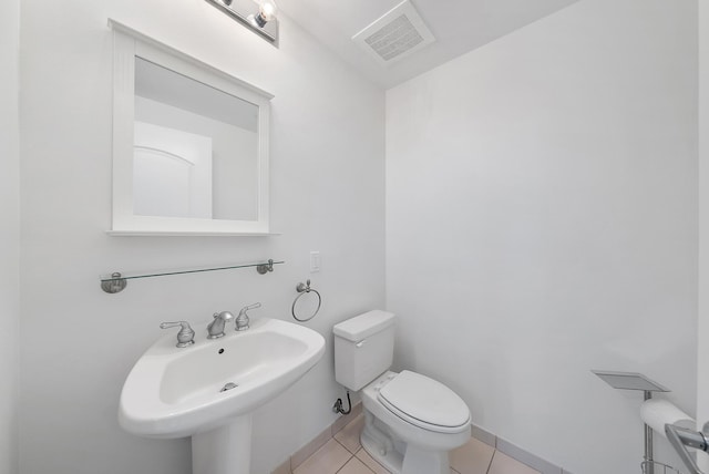 bathroom featuring tile patterned flooring, toilet, and sink