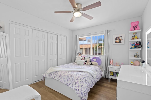 bedroom with a closet, ceiling fan, and dark wood-type flooring