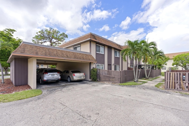 view of property exterior with a carport