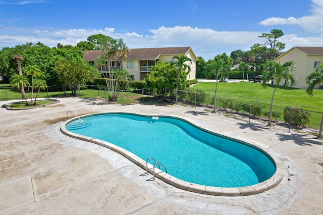 view of pool featuring a yard and a patio area