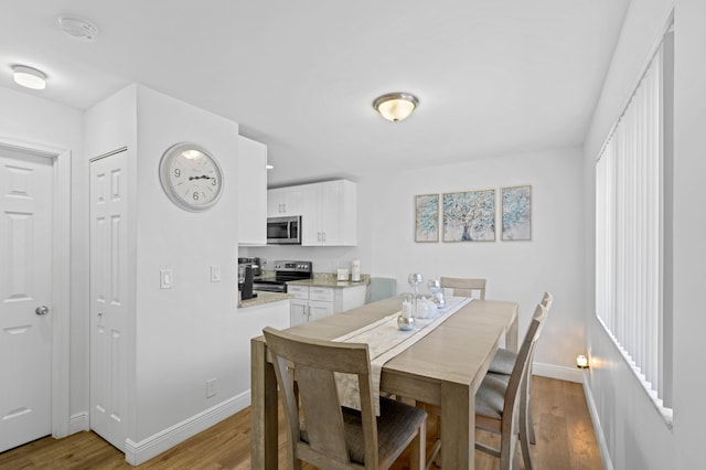 dining room featuring light hardwood / wood-style floors