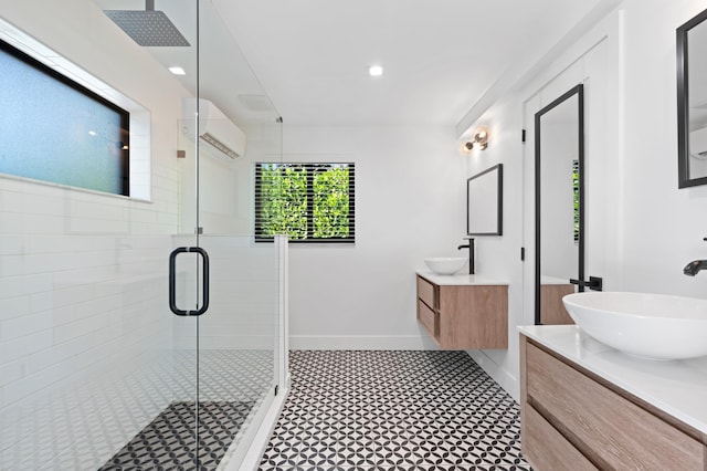 bathroom featuring walk in shower, vanity, and a wall mounted AC