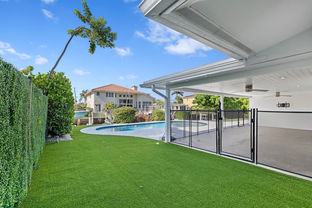 view of pool featuring ceiling fan, a yard, and a patio area