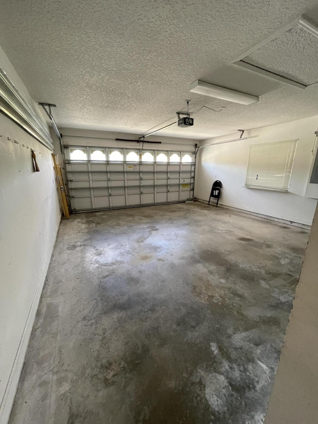 565 SW New Castle Cv, Port Saint Lucie, FL 34986 - garage with a garage door opener and baseboards