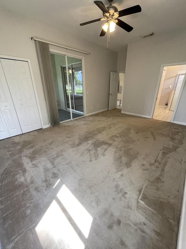 565 SW New Castle Cv, Port Saint Lucie, FL 34986 - unfurnished bedroom with access to exterior, ceiling fan, and carpet floors