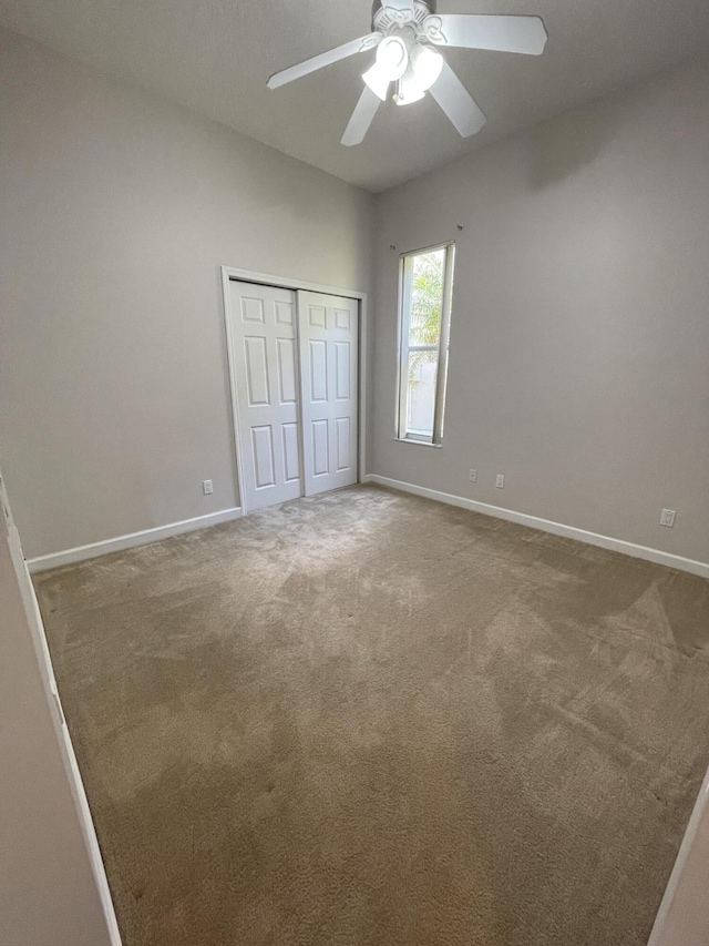 565 SW New Castle Cv, Port Saint Lucie, FL 34986 - unfurnished bedroom with a closet, carpet floors, and a ceiling fan