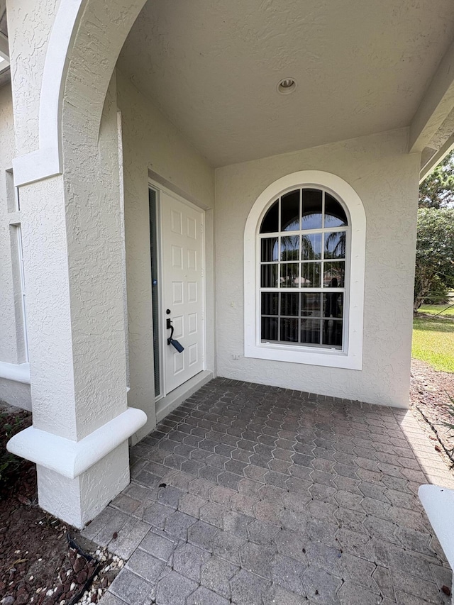 565 SW New Castle Cv, Port Saint Lucie, FL 34986 - view of exterior entry with stucco siding