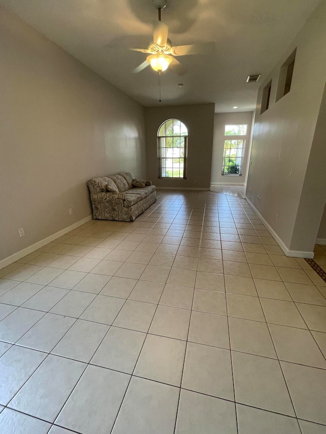 unfurnished room with ceiling fan and light tile patterned flooring