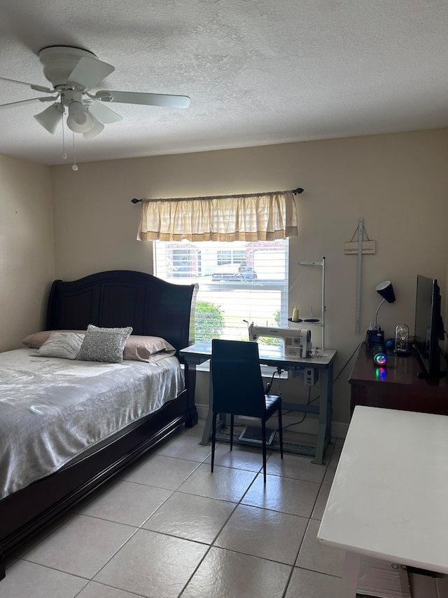 tiled bedroom featuring ceiling fan and a textured ceiling