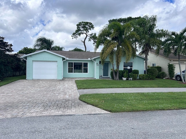 single story home featuring a front yard and a garage