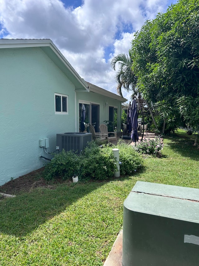 view of yard featuring a patio and central AC unit