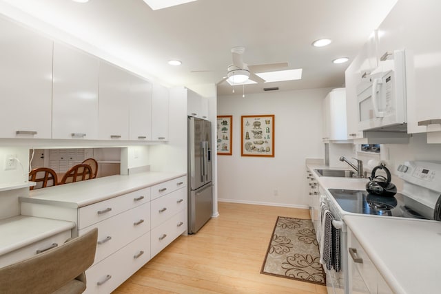 kitchen with stainless steel fridge with ice dispenser, light hardwood / wood-style flooring, white cabinets, and range