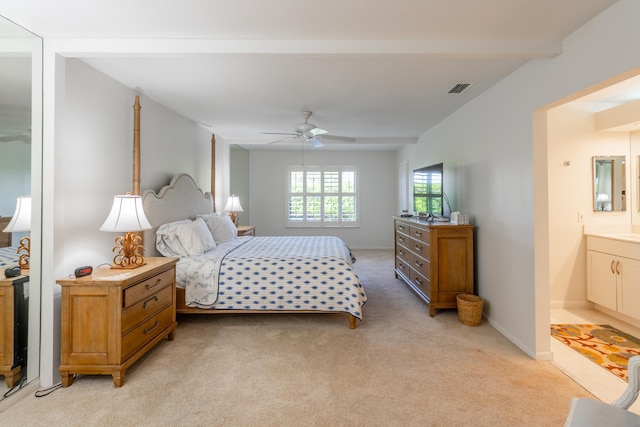 bedroom featuring ensuite bathroom, ceiling fan, and light colored carpet