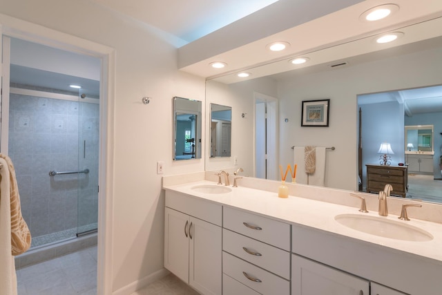 bathroom with tile patterned flooring, vanity, and an enclosed shower