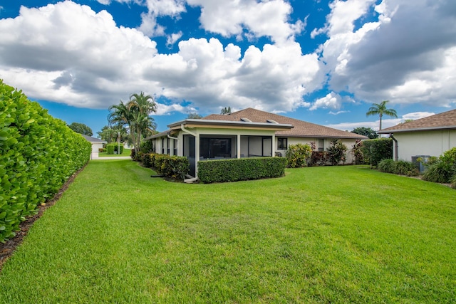 exterior space featuring a lawn and a sunroom