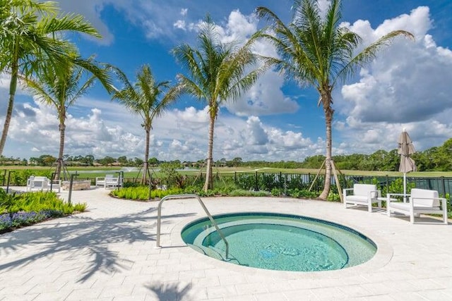 view of pool featuring an in ground hot tub and a patio area